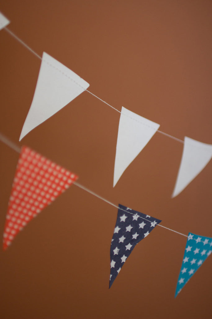 Multi-Color Paper Flag Garland on a Wood Spool